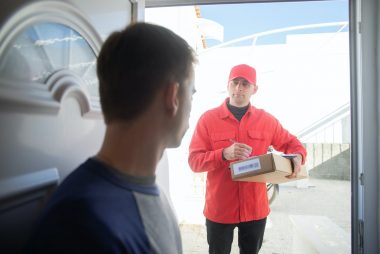 a delivery man carrying a box