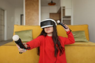 woman in red long sleeves using virtual reality gadgets